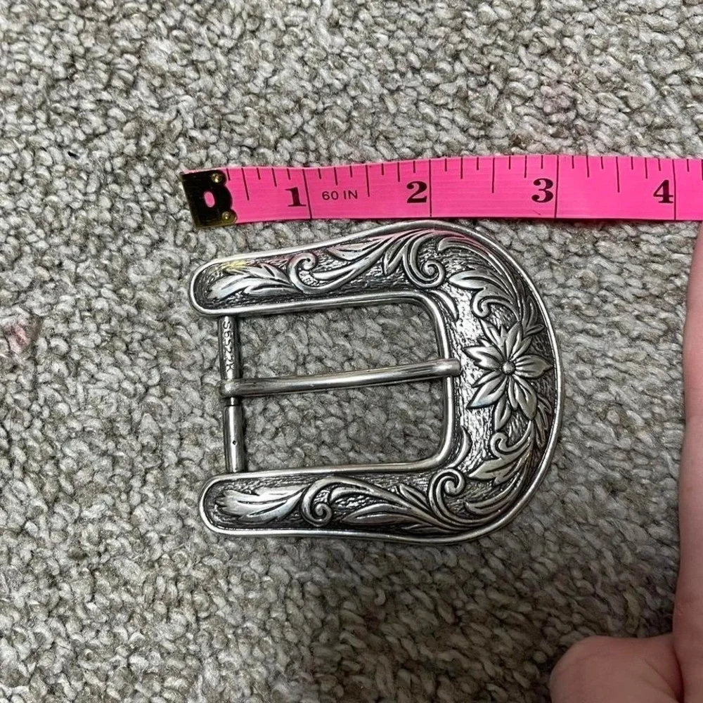 silver belt buckle with floral detailing